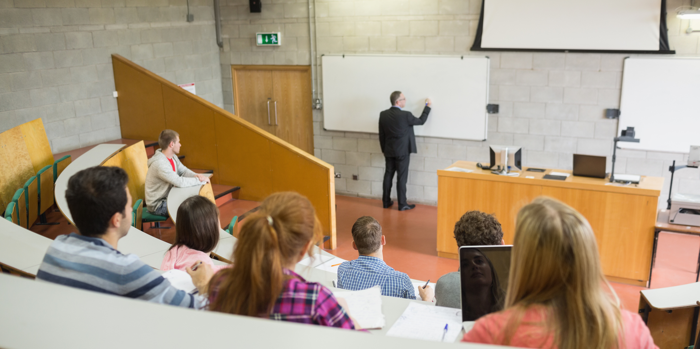 Male teacher with students at the lecture hall