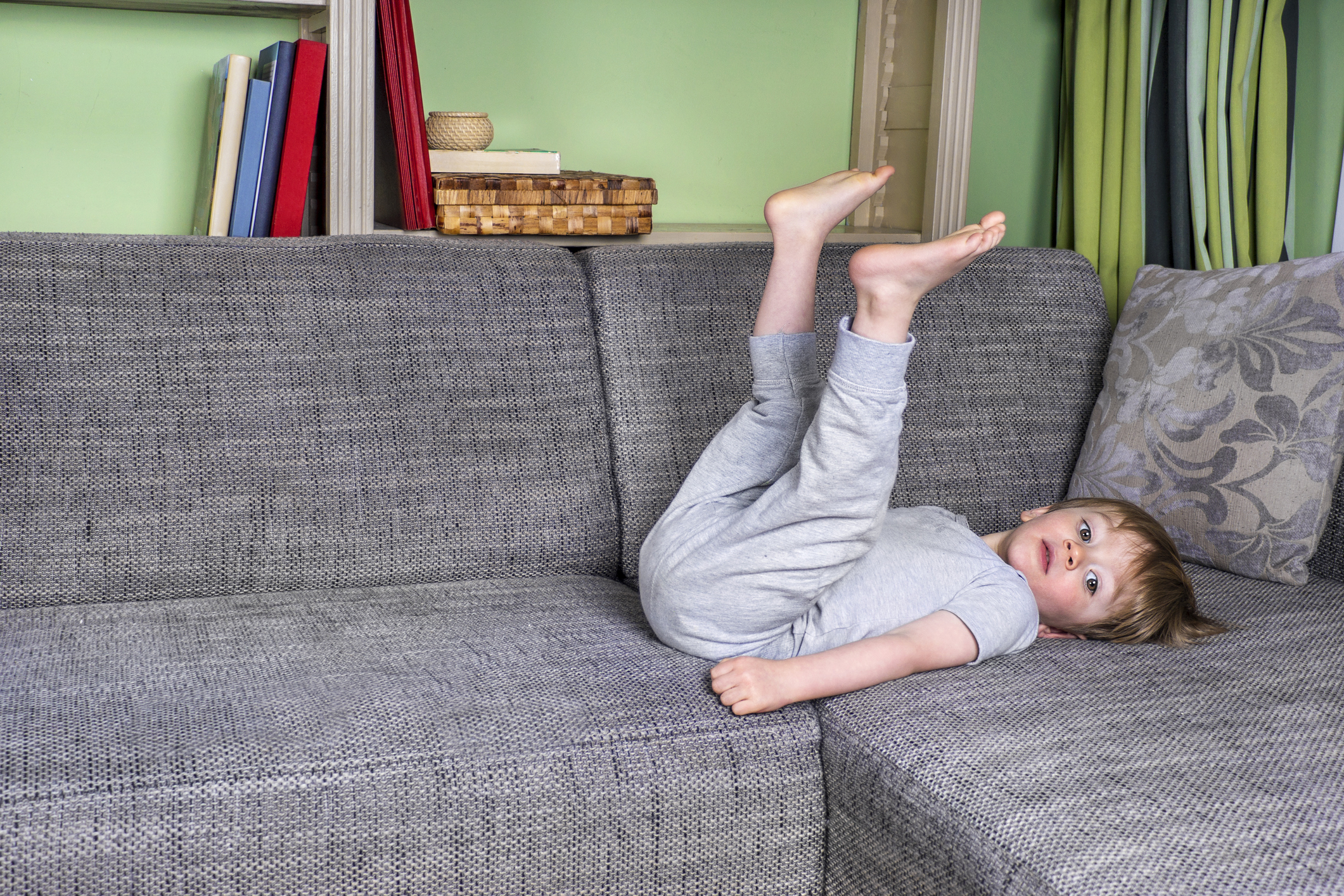 Little kid hanging around on the couch