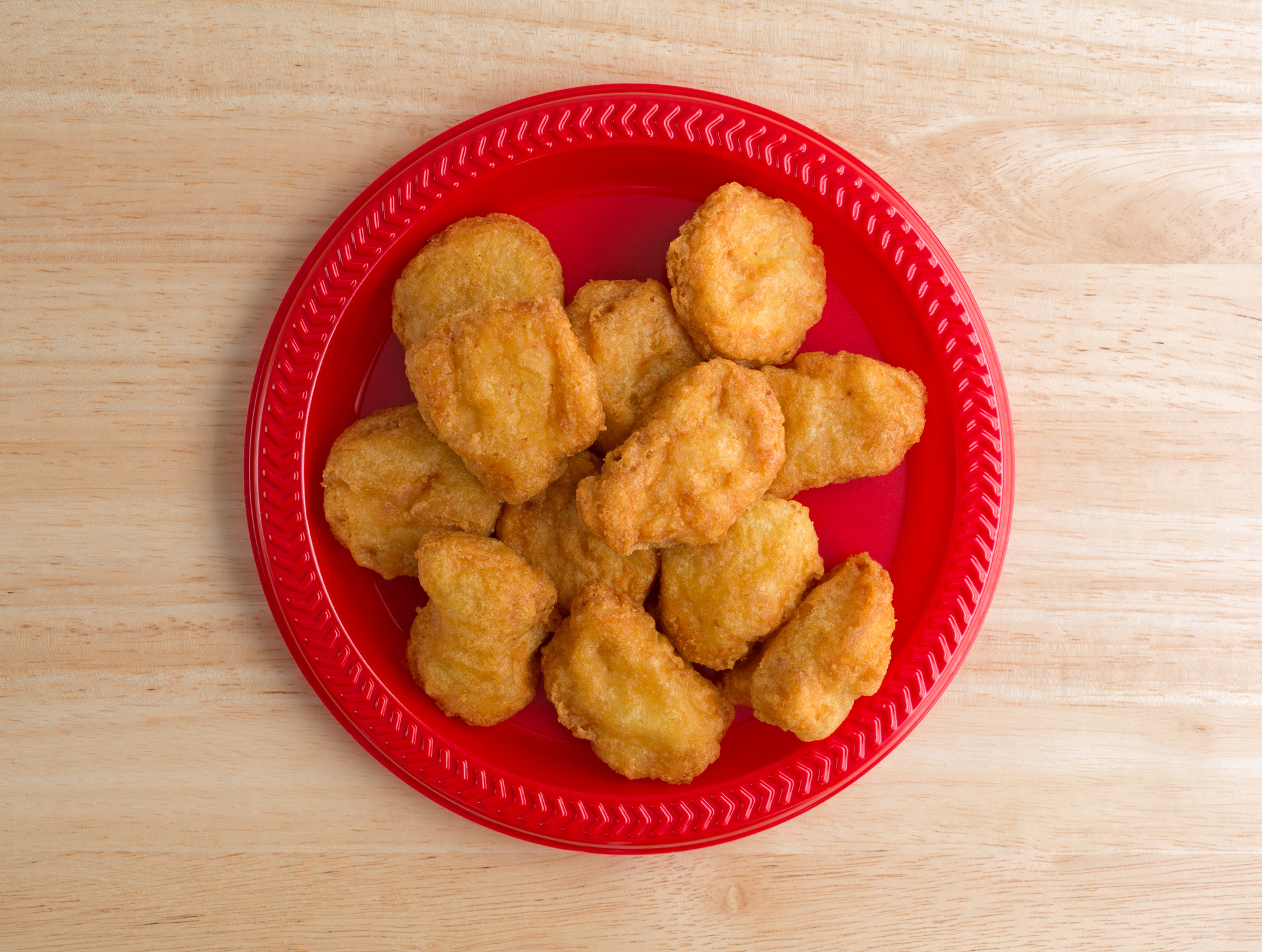 Chicken nuggets on a small red plate