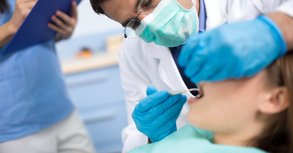 Dentist check up and repair tooth of young girl