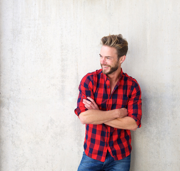 Confident smiling man posing with arms crossed