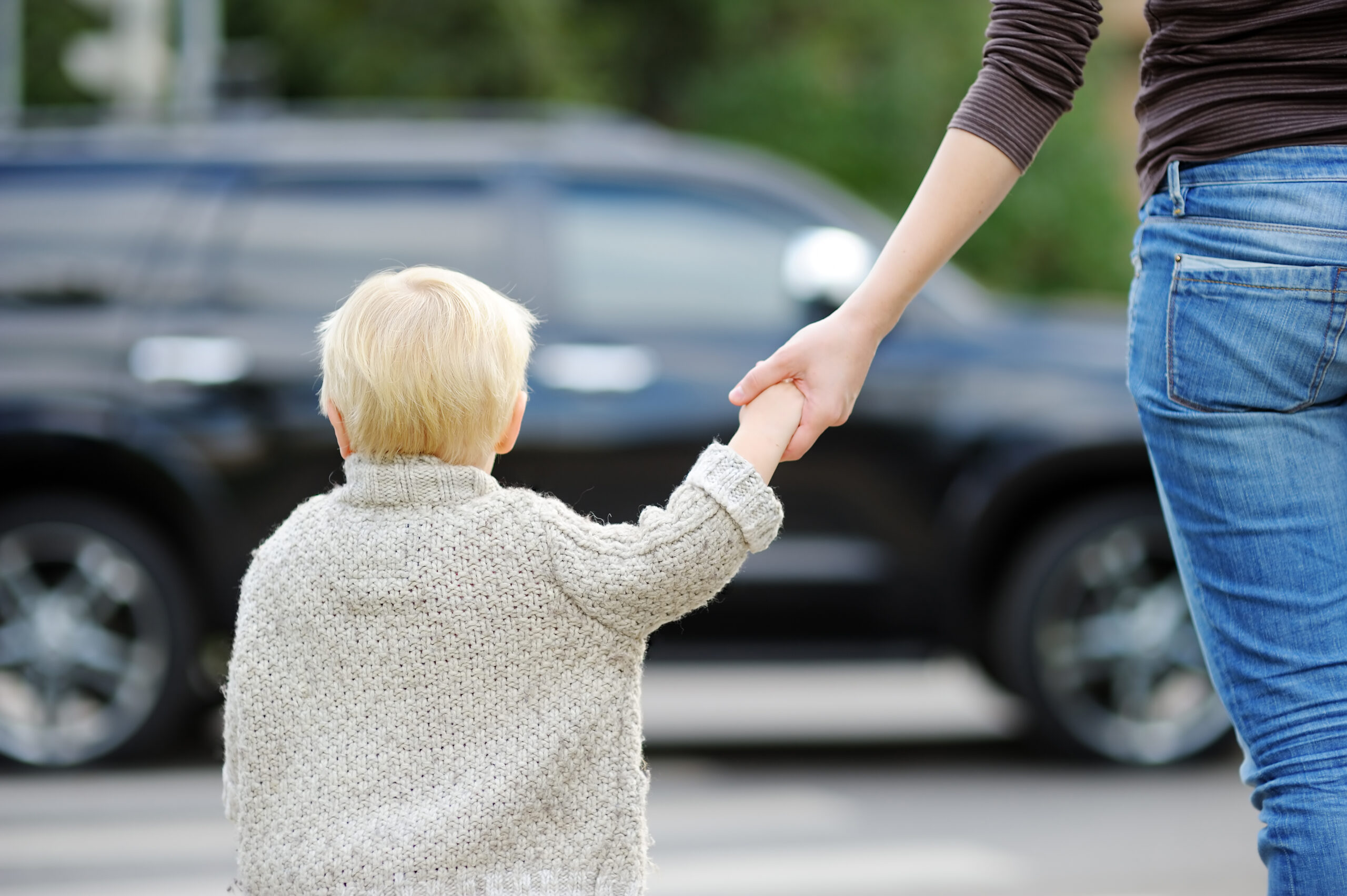 Mother and son crossing street on the crosswalk