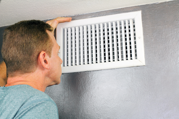 Inspecting a Home Air Vent for Maintenance