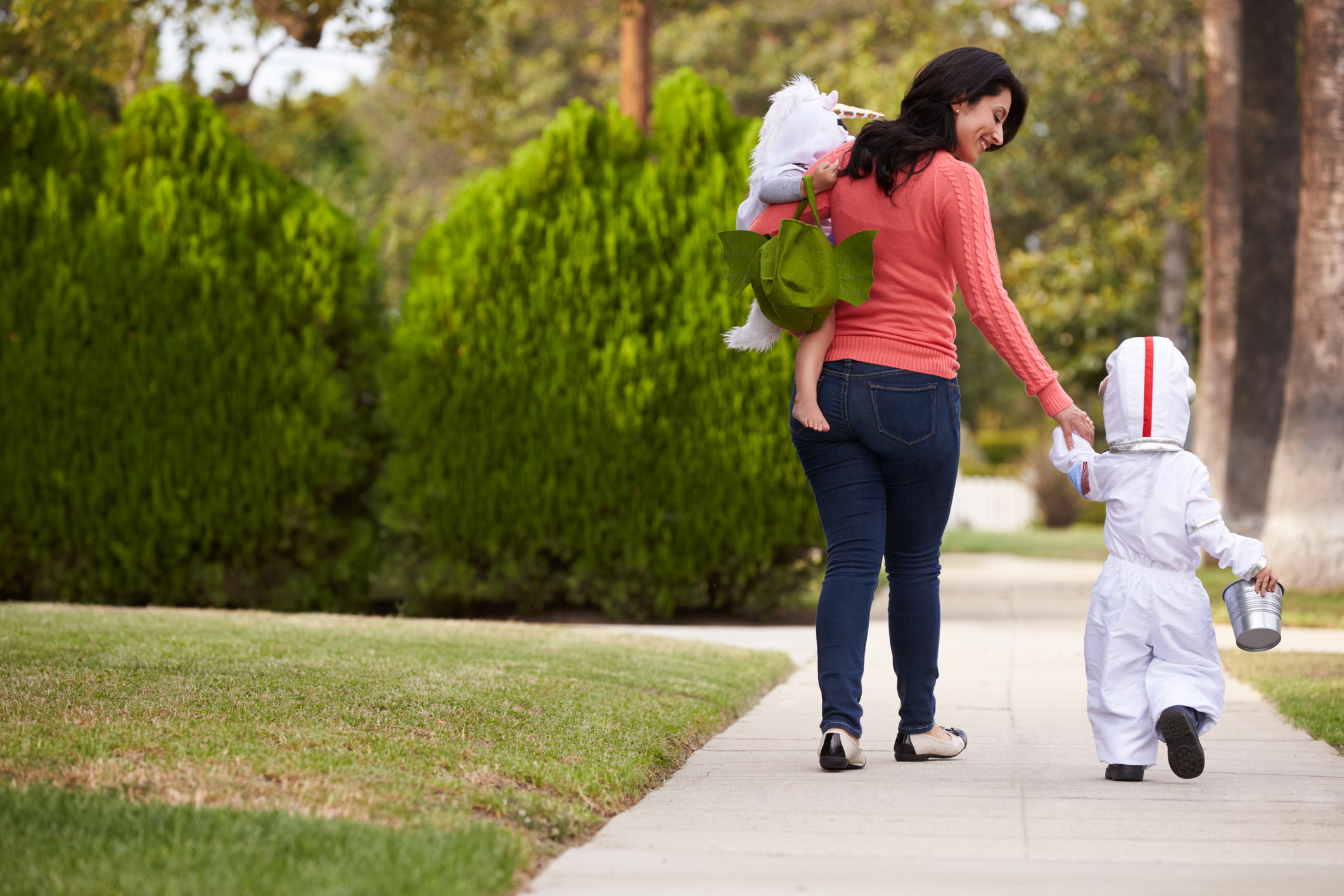 Parent Taking Children Trick Or Treating At Halloween