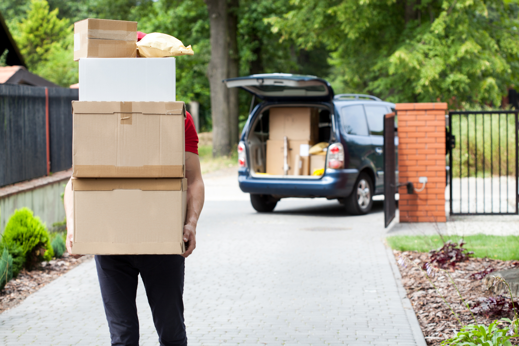 Delivery man carrying package stack