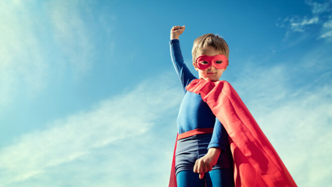 Superhero kid in red cape and mask