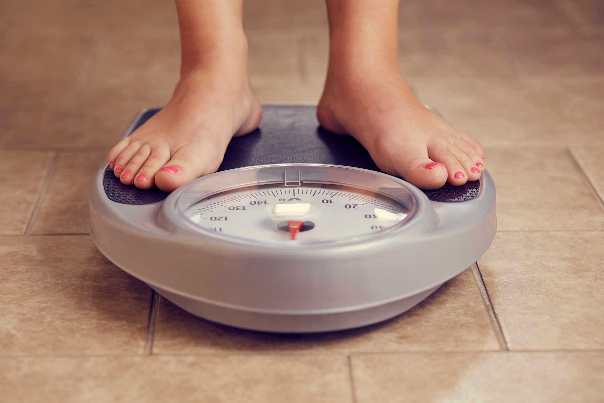 Female feet on a bathroom scale