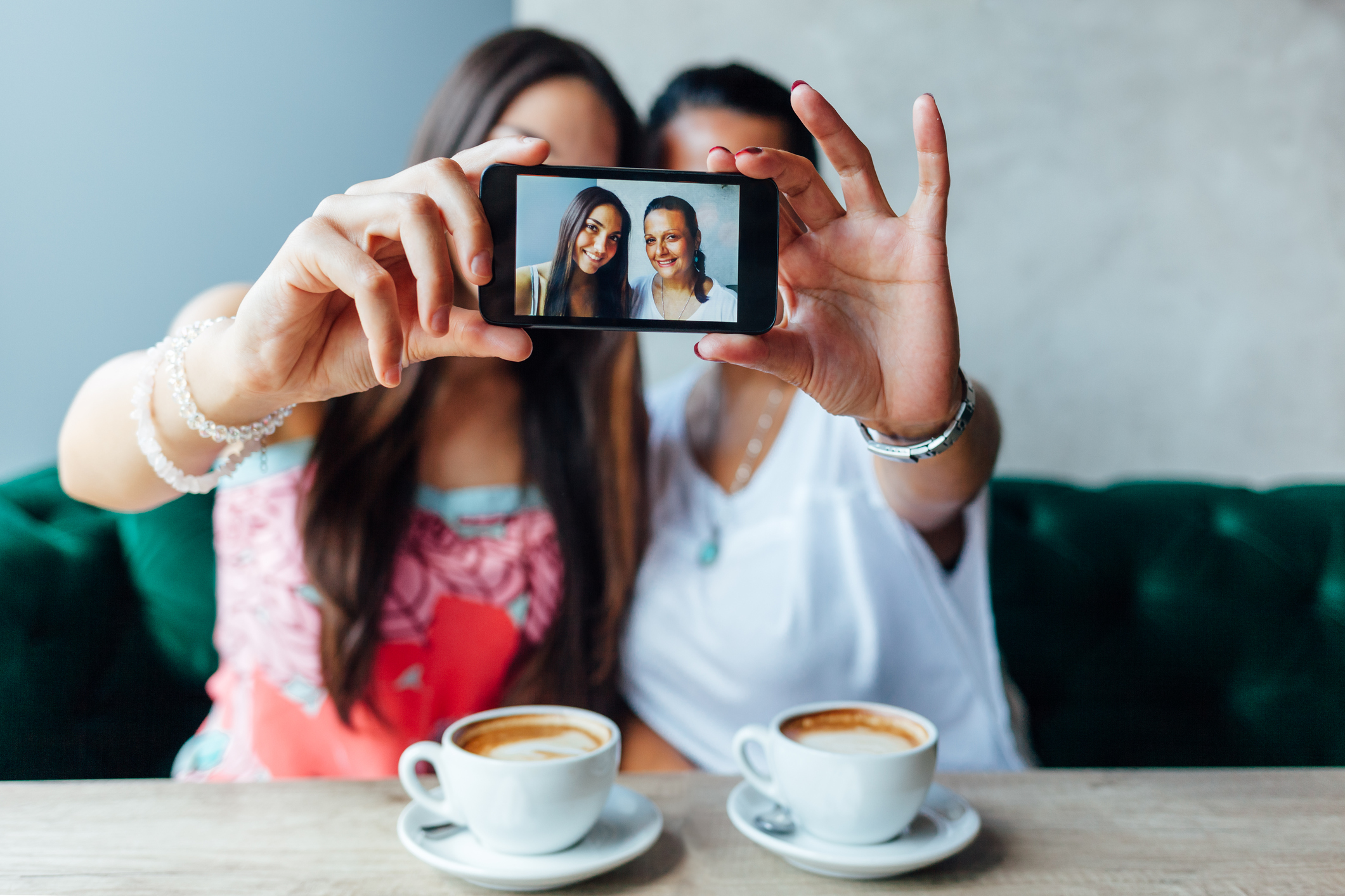 Two women making selfie in a cafe