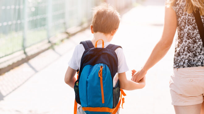 7 years old boy going to school with his mother