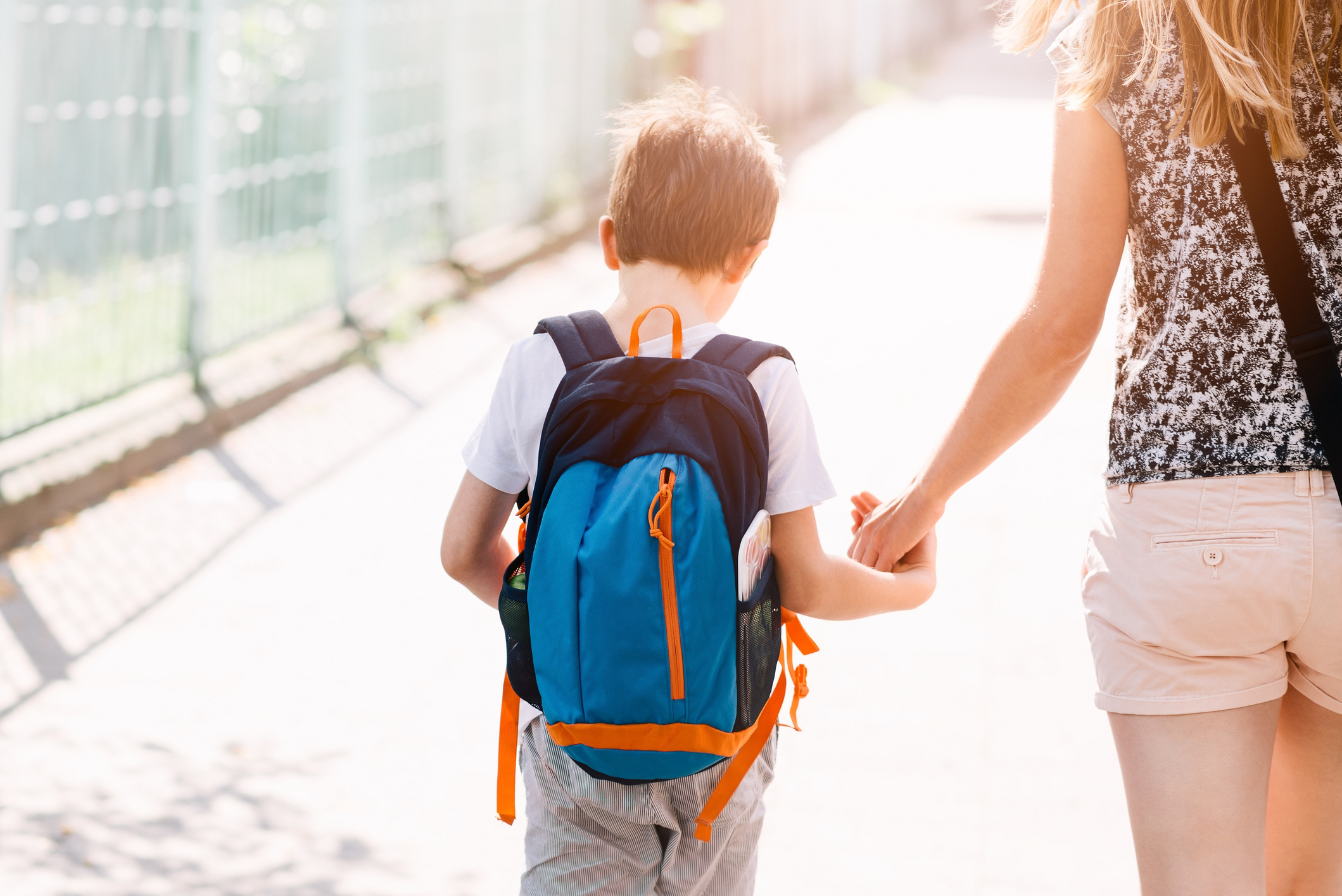 7 years old boy going to school with his mother