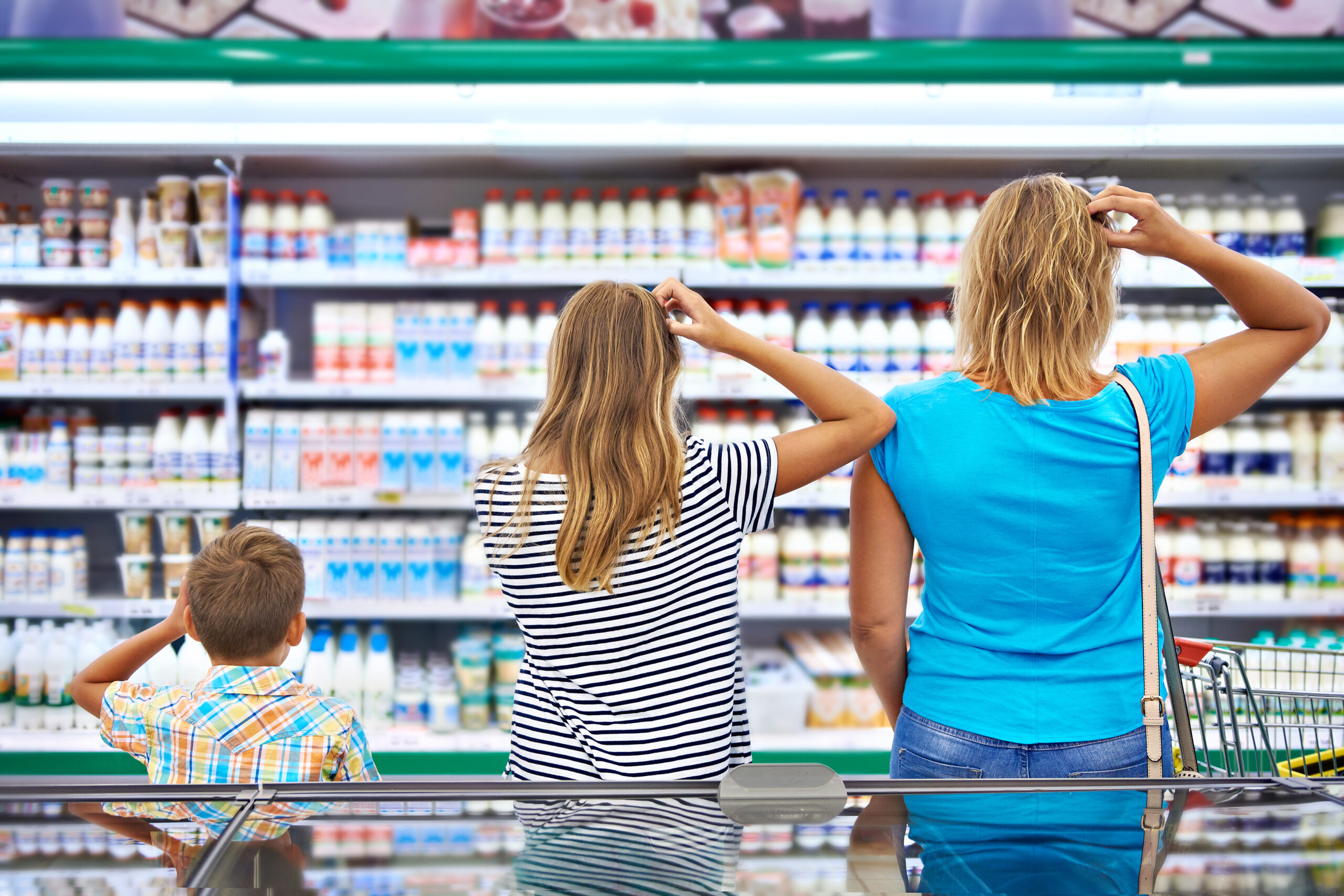 Family chooses dairy products in shop