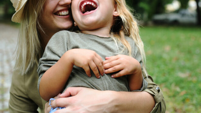 Cheerful mother with her daughter outdoor.