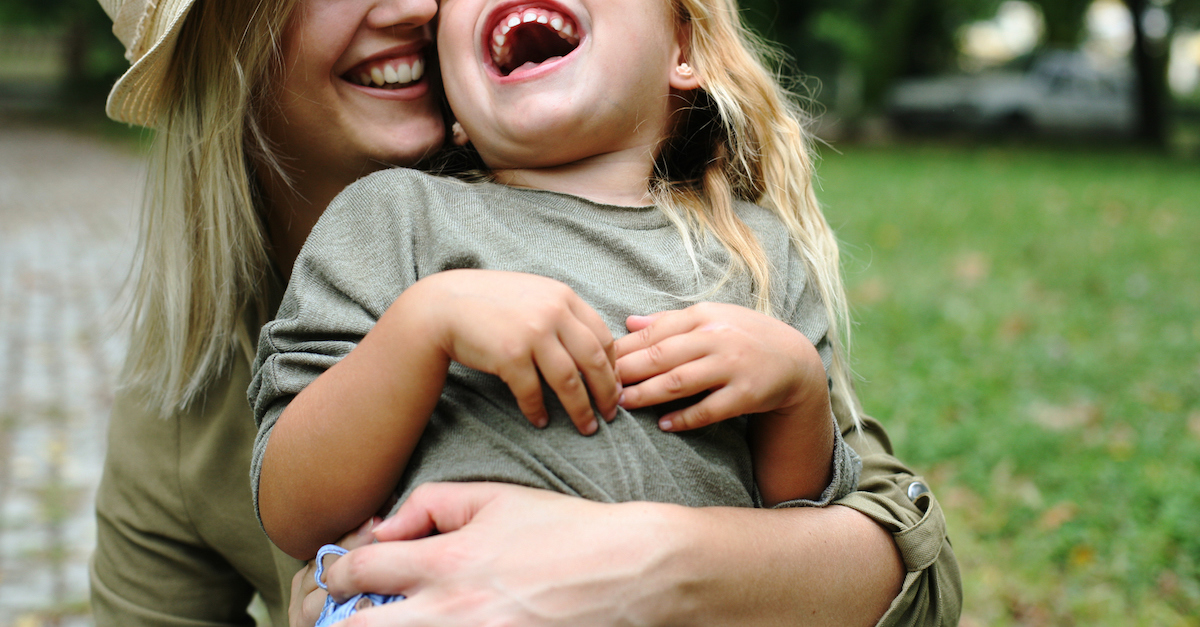 Cheerful mother with her daughter outdoor.