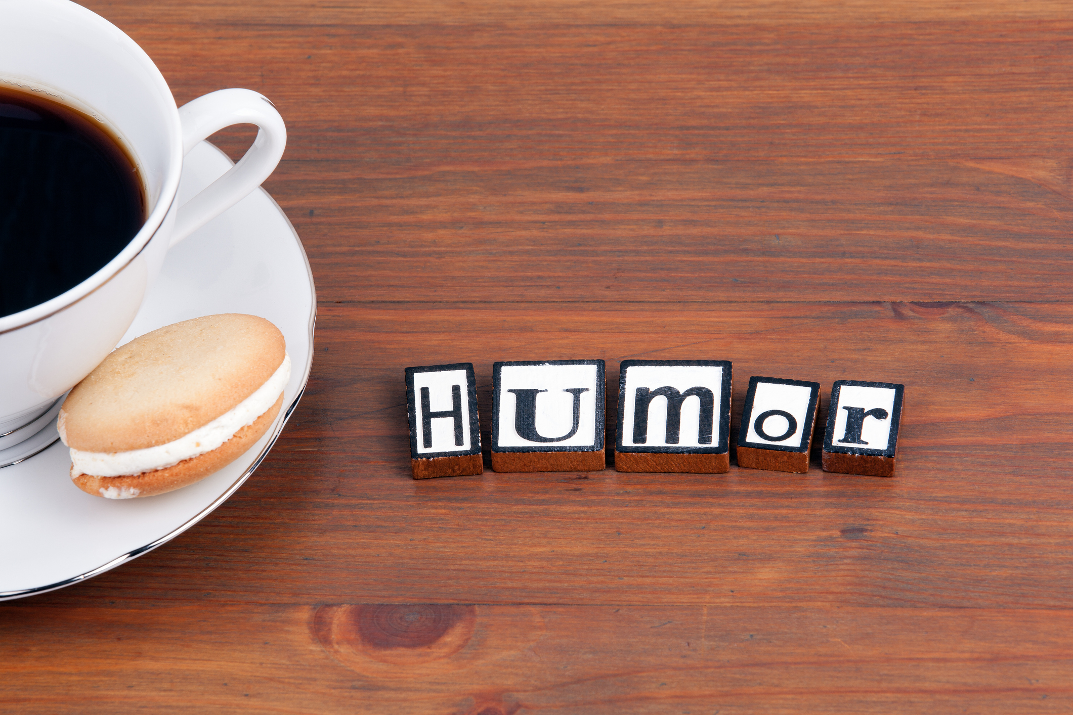 Coffee cup on a wooden table and text - Humor