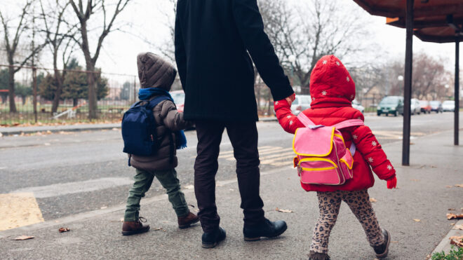 Dad with kids going to the bus stop