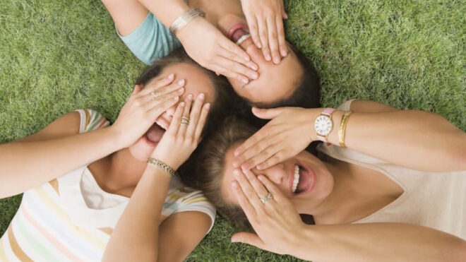 Multi-ethnic girls laying on grass