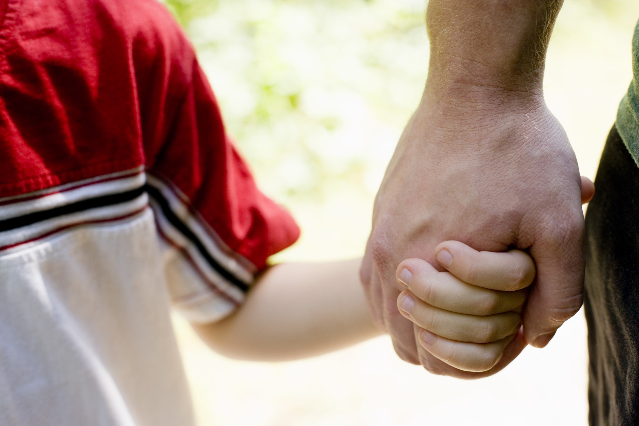 Father and son holding hands