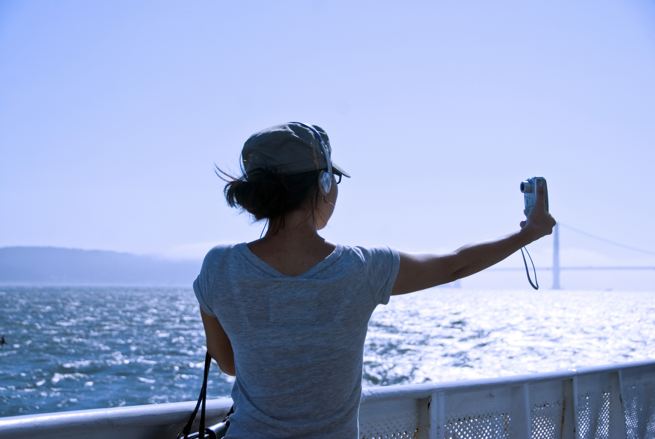 USA, California, San Francisco, Rear view of woman taking picture of herself with digital camera