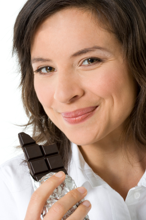 Close-up of a young woman eating chocolate