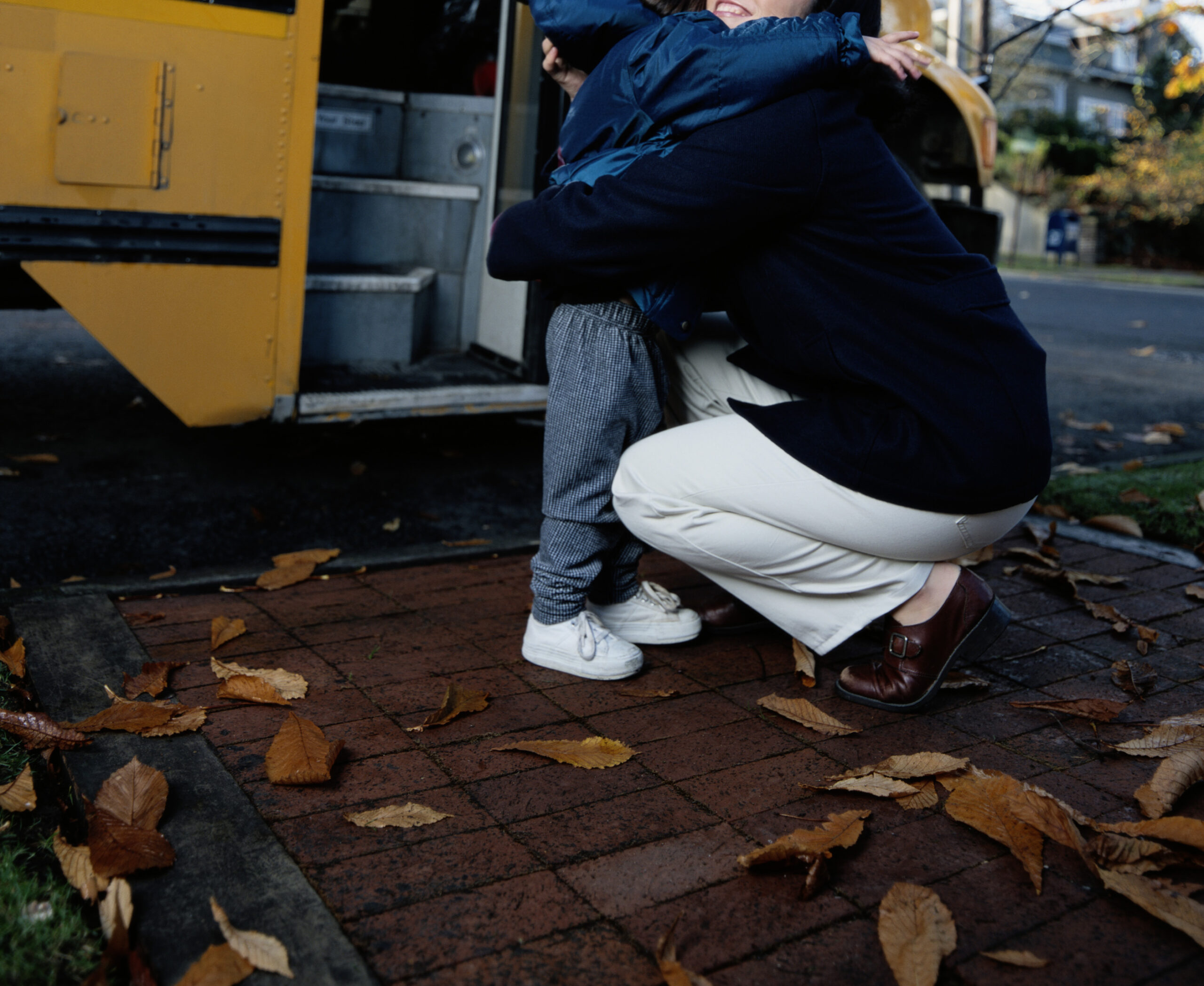 Mother Hugging Daughter at the School Bus