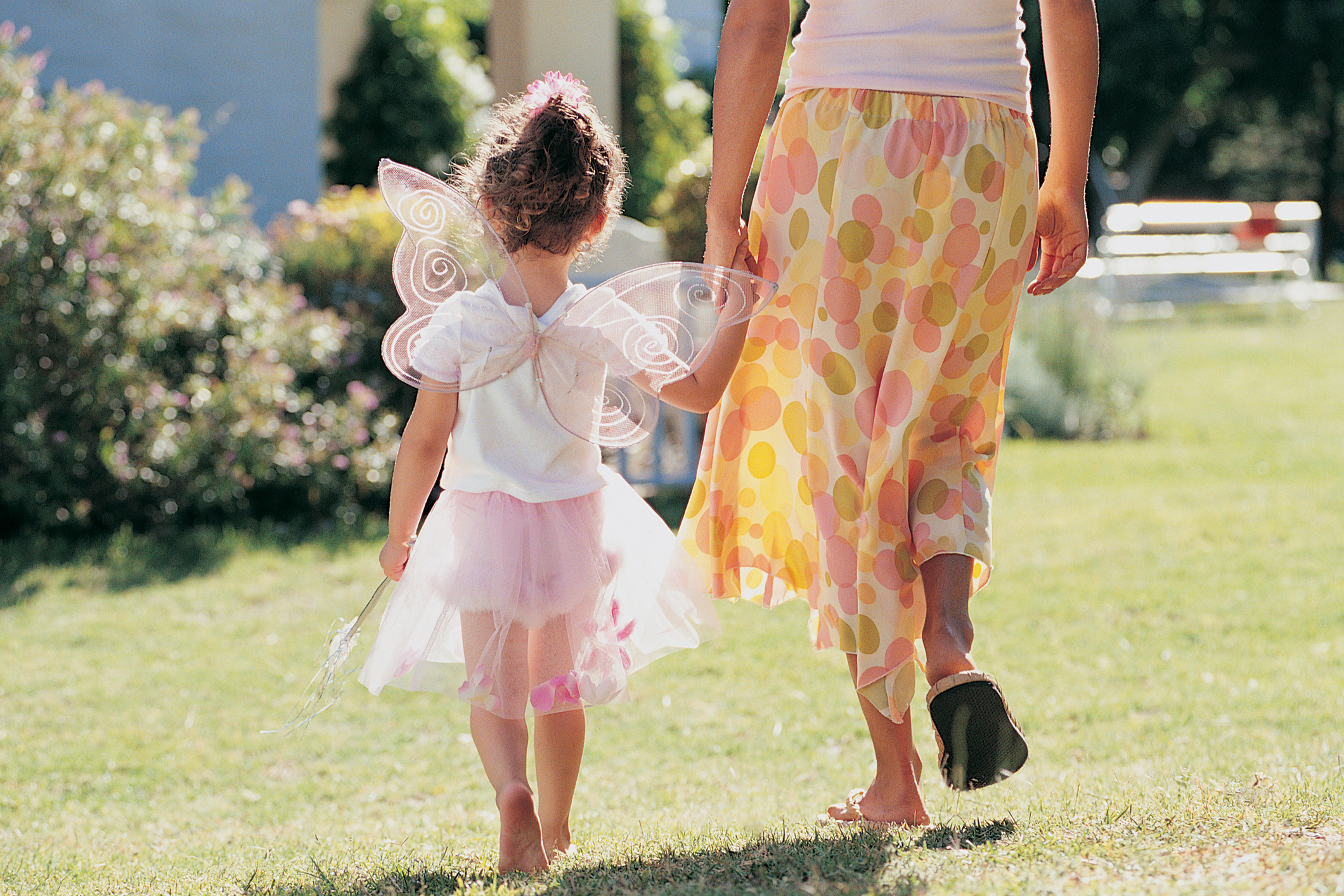 Young Girl in Fairy Fancy Dress Walking in the Garden With Her Mother Holding Hands