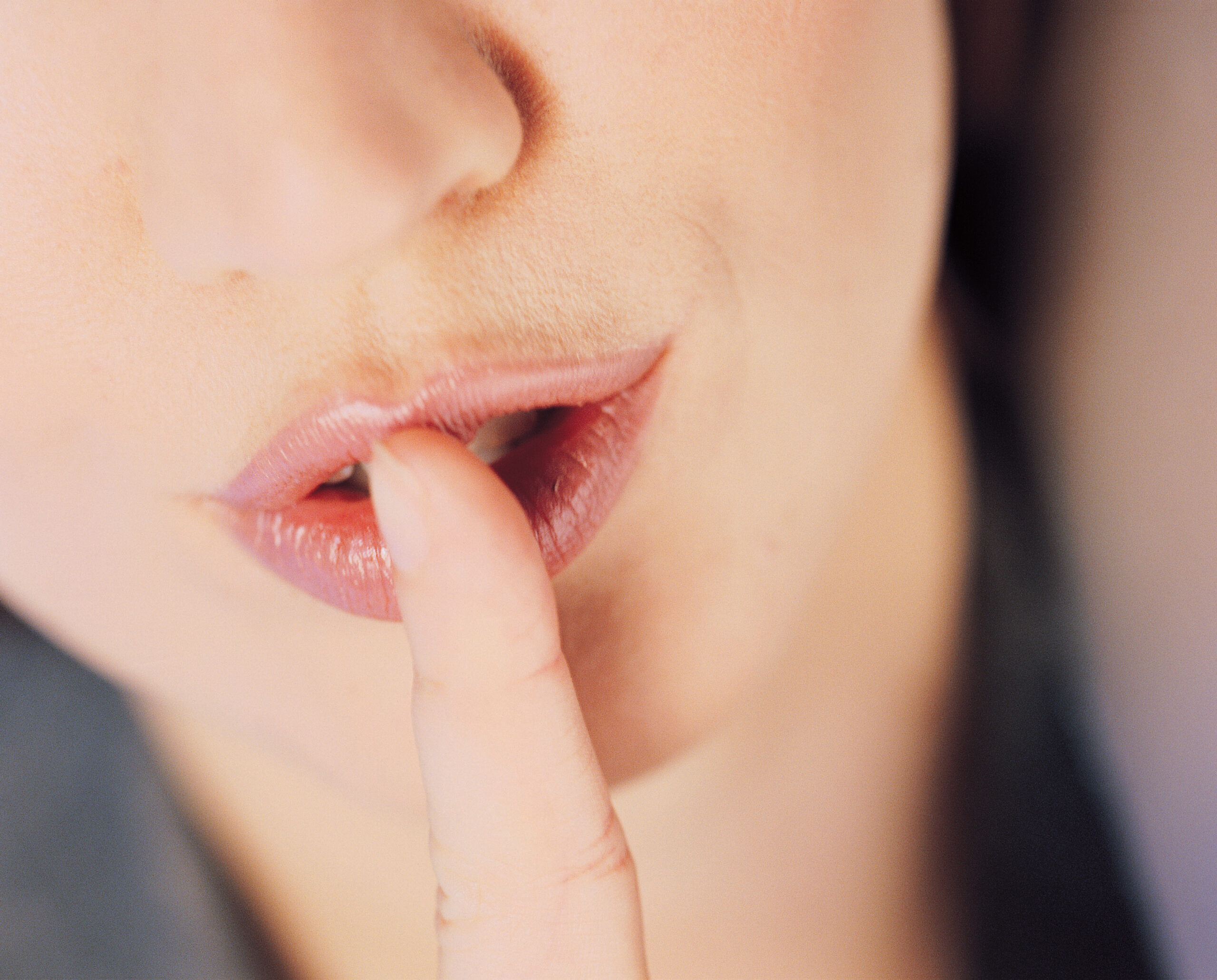 Woman holding finger to her lips