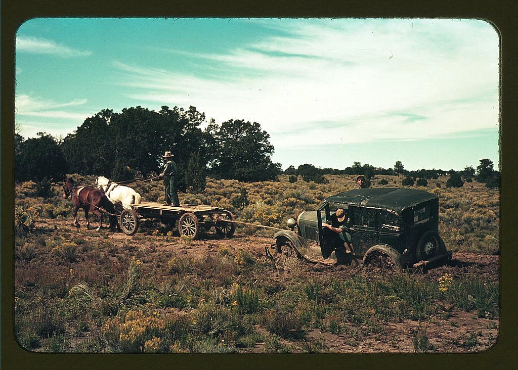 a-horse-and-cart-team-pulling-a-car-out-of-the-mud-on-a-road-near-pie-town-new-mexico-in-late-1940.jpg