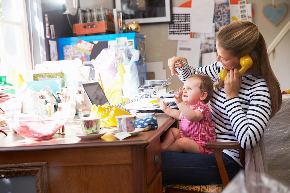 Mother With Daughter Running Small Business From Home Office