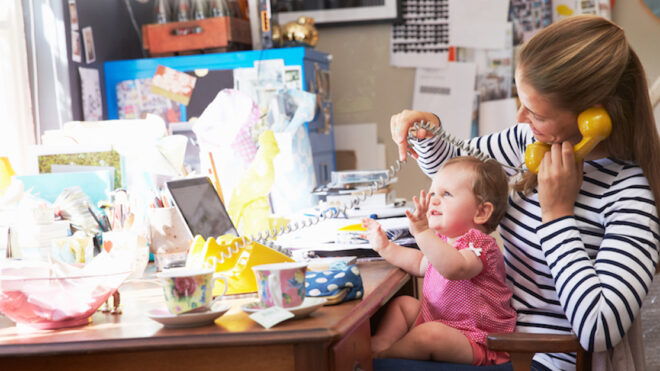 Mother With Daughter Running Small Business From Home Office