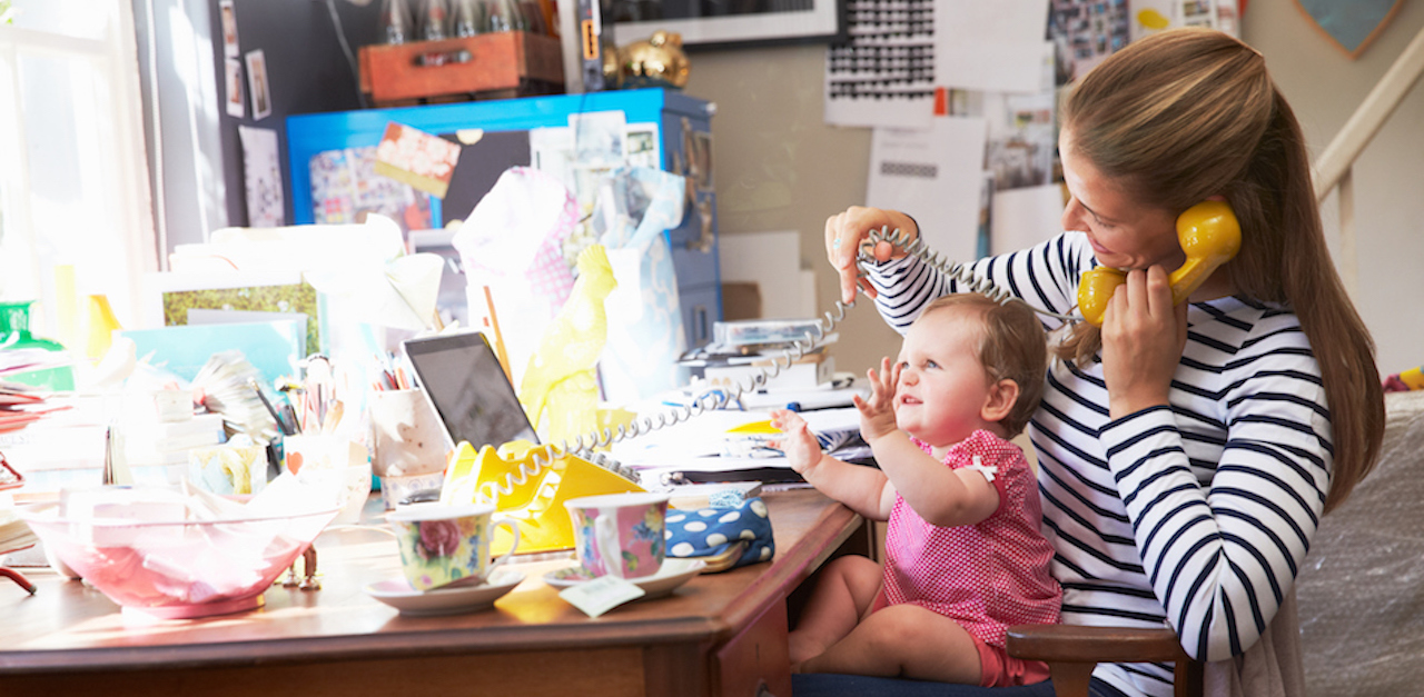 Mother With Daughter Running Small Business From Home Office