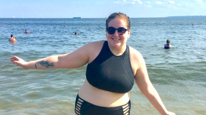 at the beach in two piece bathing suit