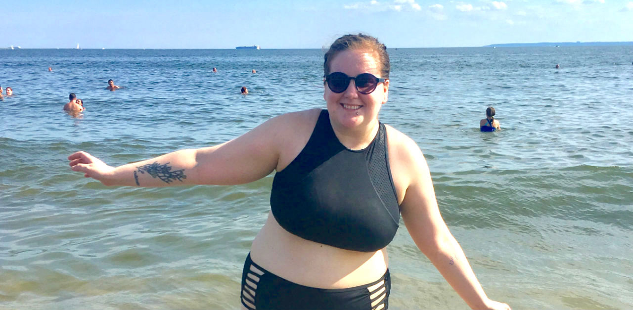 at the beach in two piece bathing suit