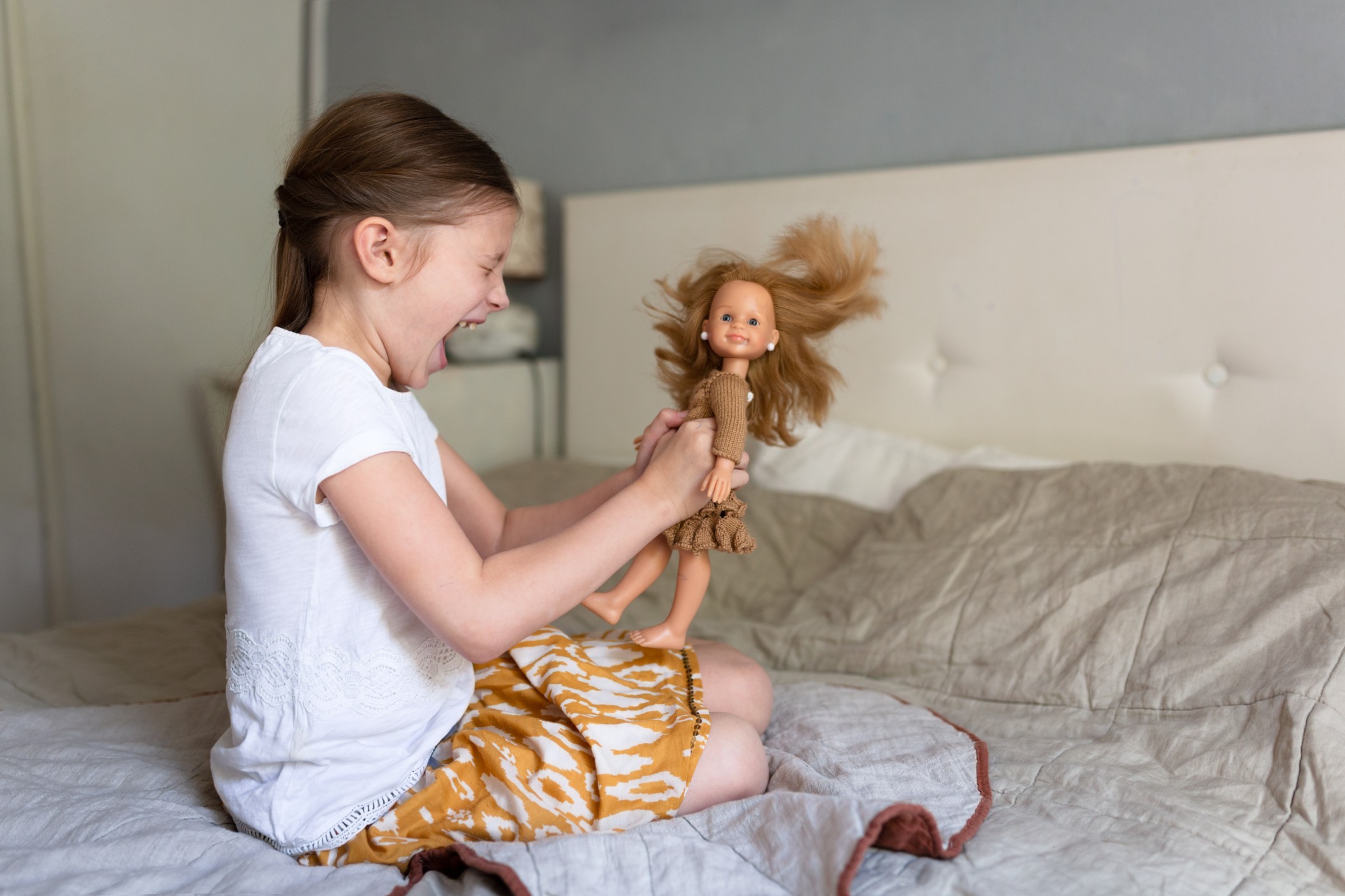 caucasian-girl-child-yells-at-a-doll-scolds-punishes-a-toy-doll-in-the-bedroom-on-the-bed-children_t20_aaAZxx.jpg