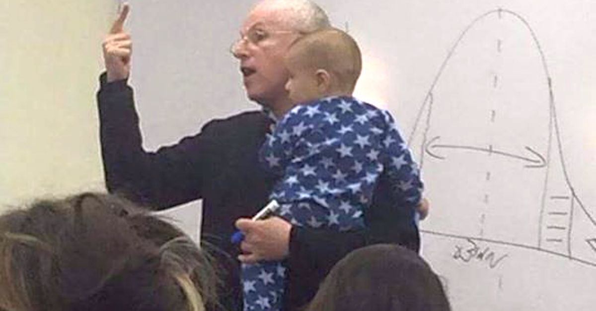 coolest professor holds students baby