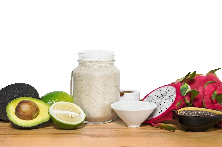 Energy smoothie in a mason jar with ingridientes on a wooden cut