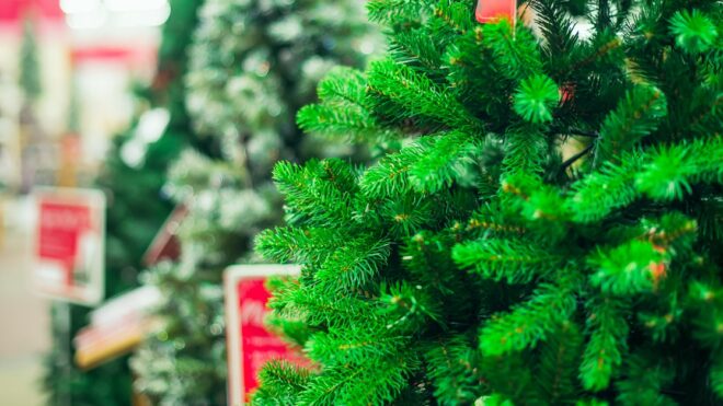 Close up artificial green Christmas trees for sale in the market