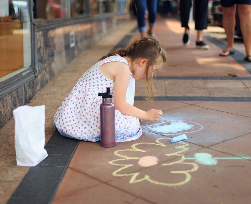 girl-drawing-on-the-floor-using-chalks-2414846.jpg