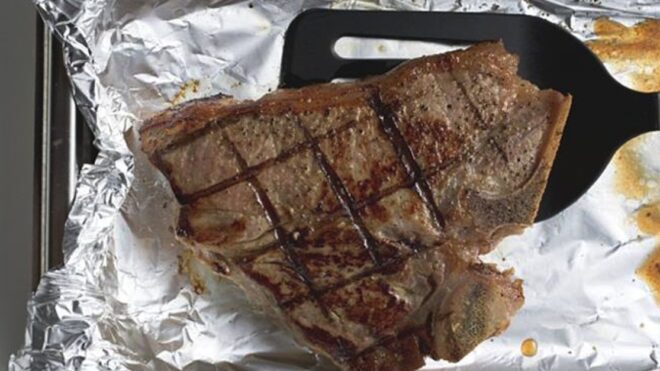 grilled_t-bone_steak_on_aluminium_foil_with_spatula_958407