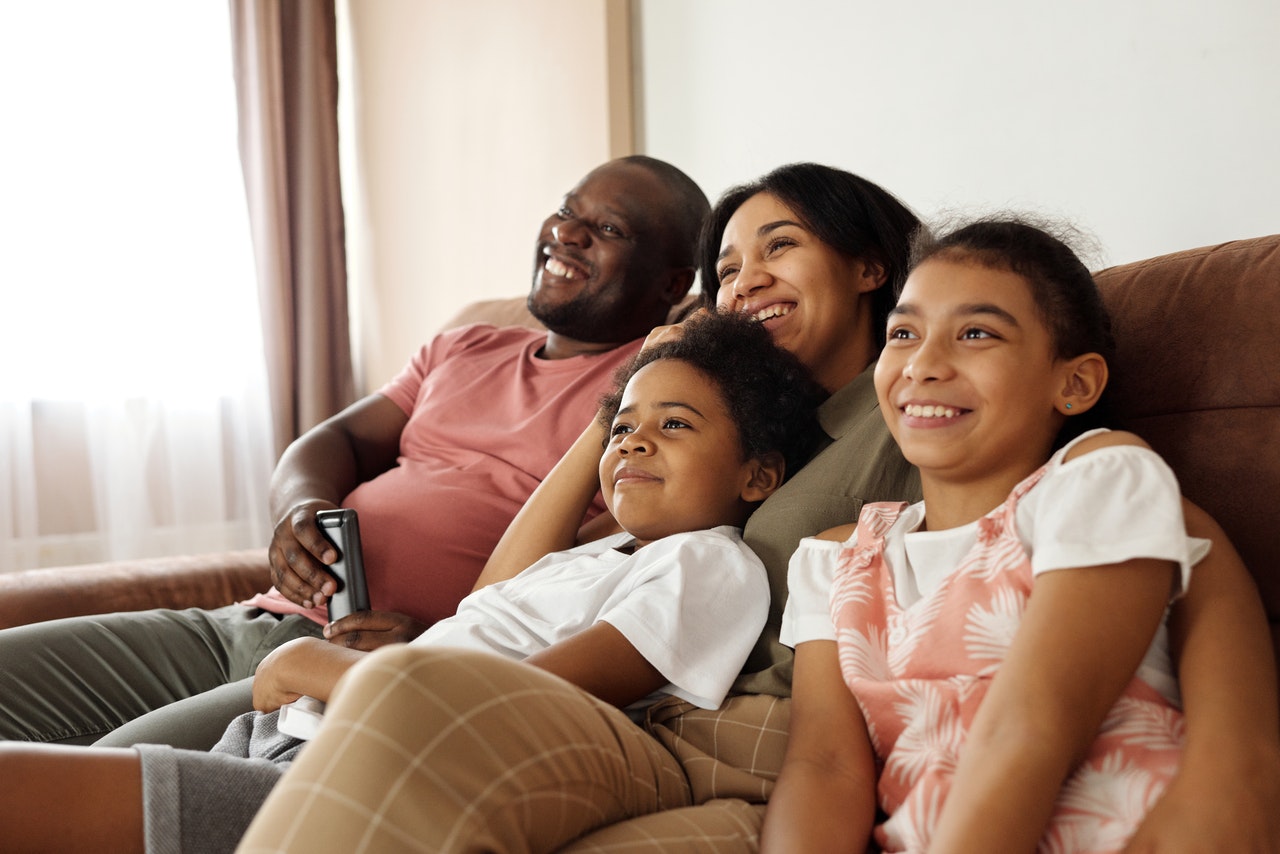 happy-family-sitting-on-a-couch-and-watching-tv-4260639.jpg