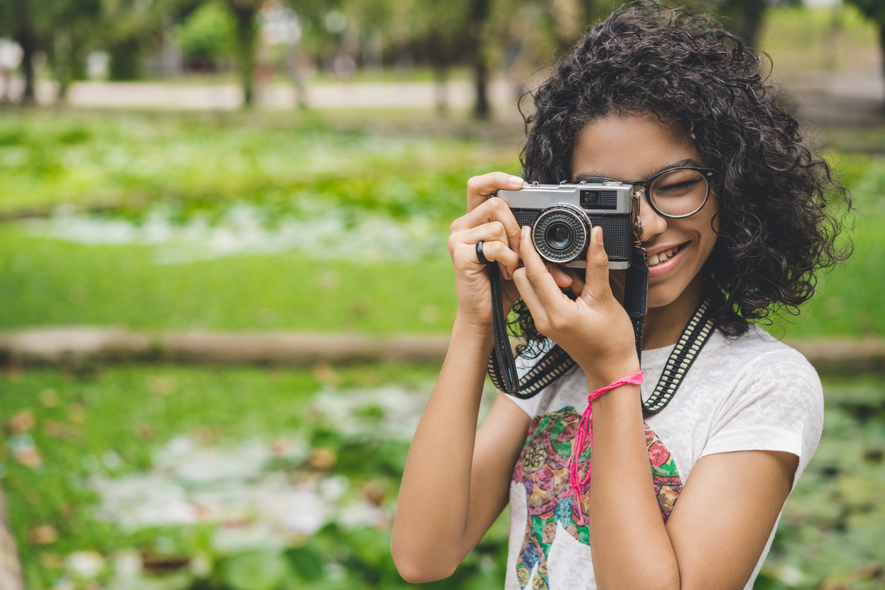 Girl taking photos in the public park