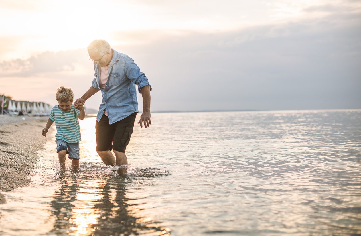 Grandfather and grandson at the beach