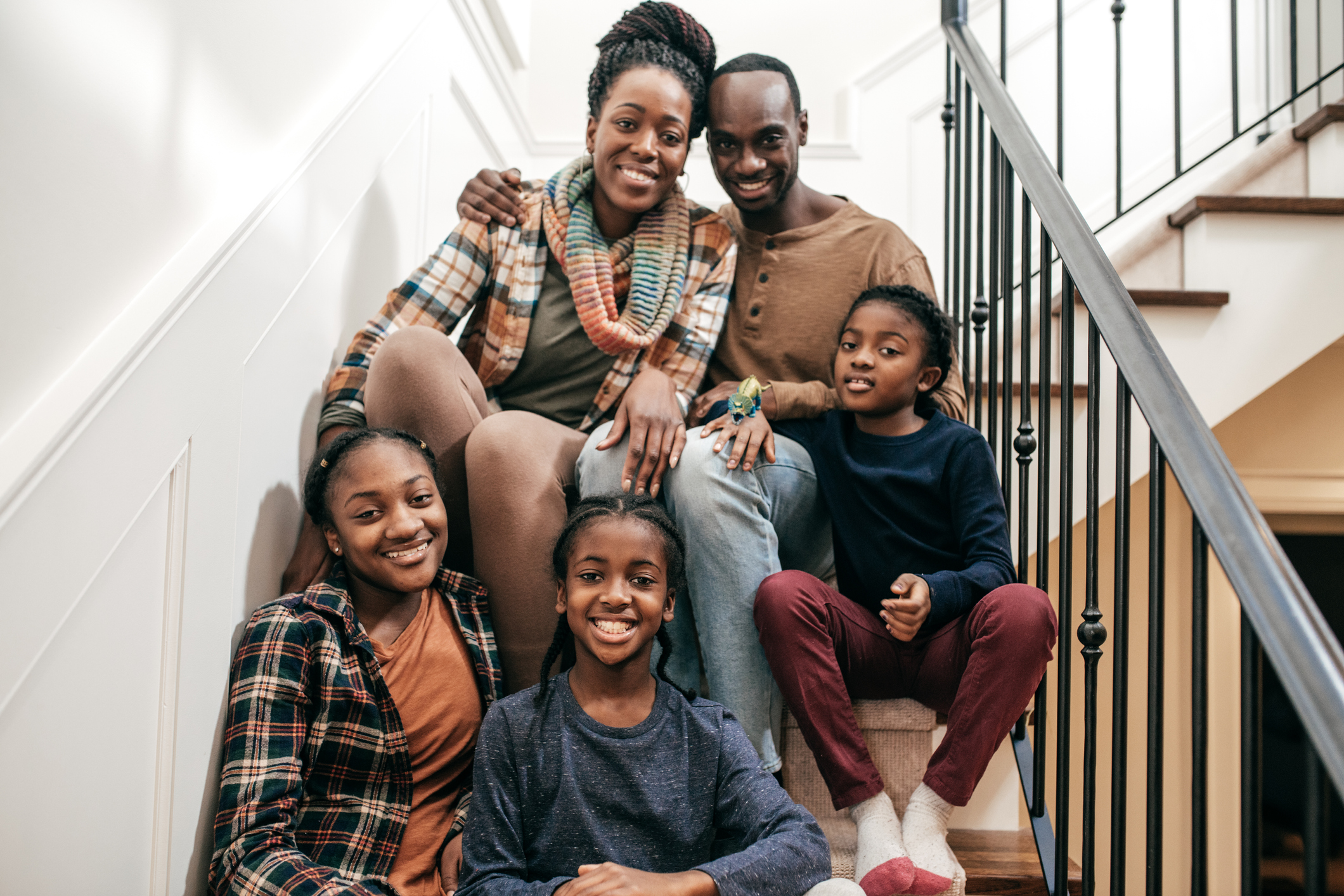 Happy parents and three children