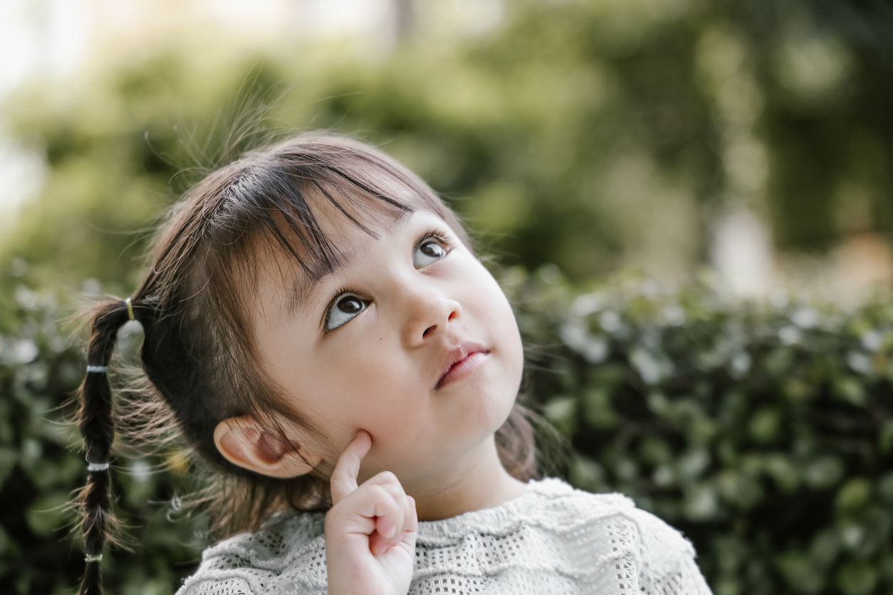 Beautiful kid playing Thinker with serious