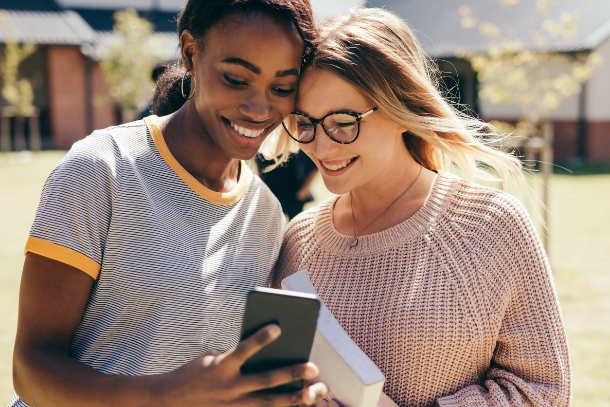 Two high school girls with mobile phone