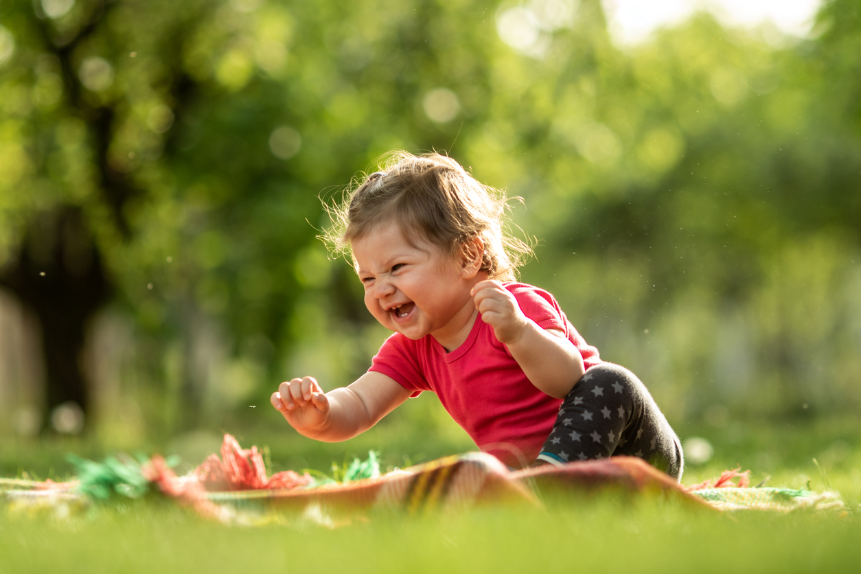 Baby boy playing in the grass