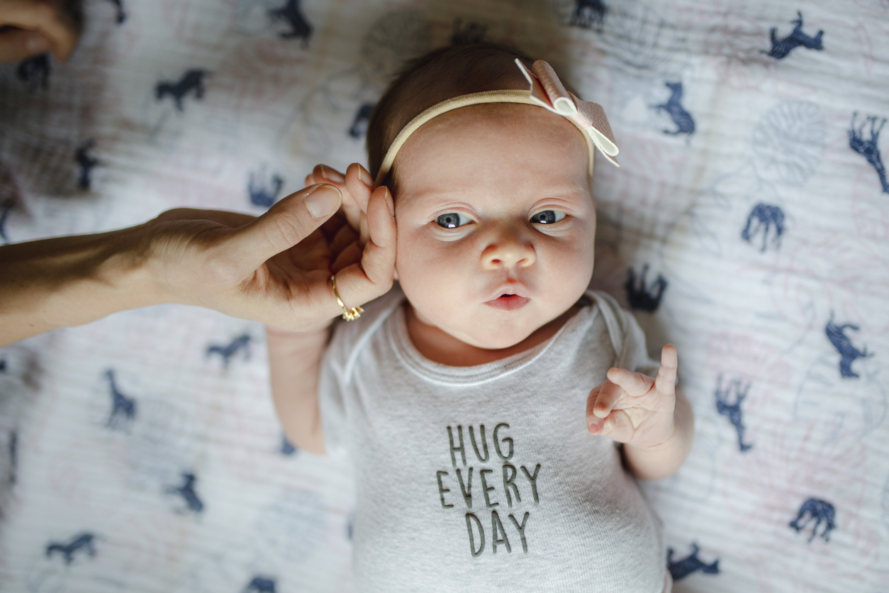 Cute newborn girl with parents and grandparents