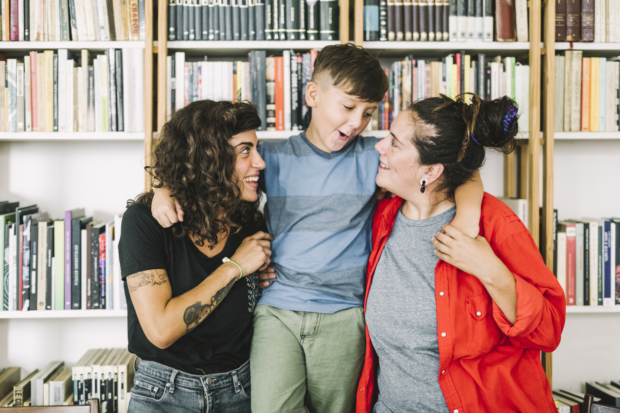 Cheerful boy with mothers at home