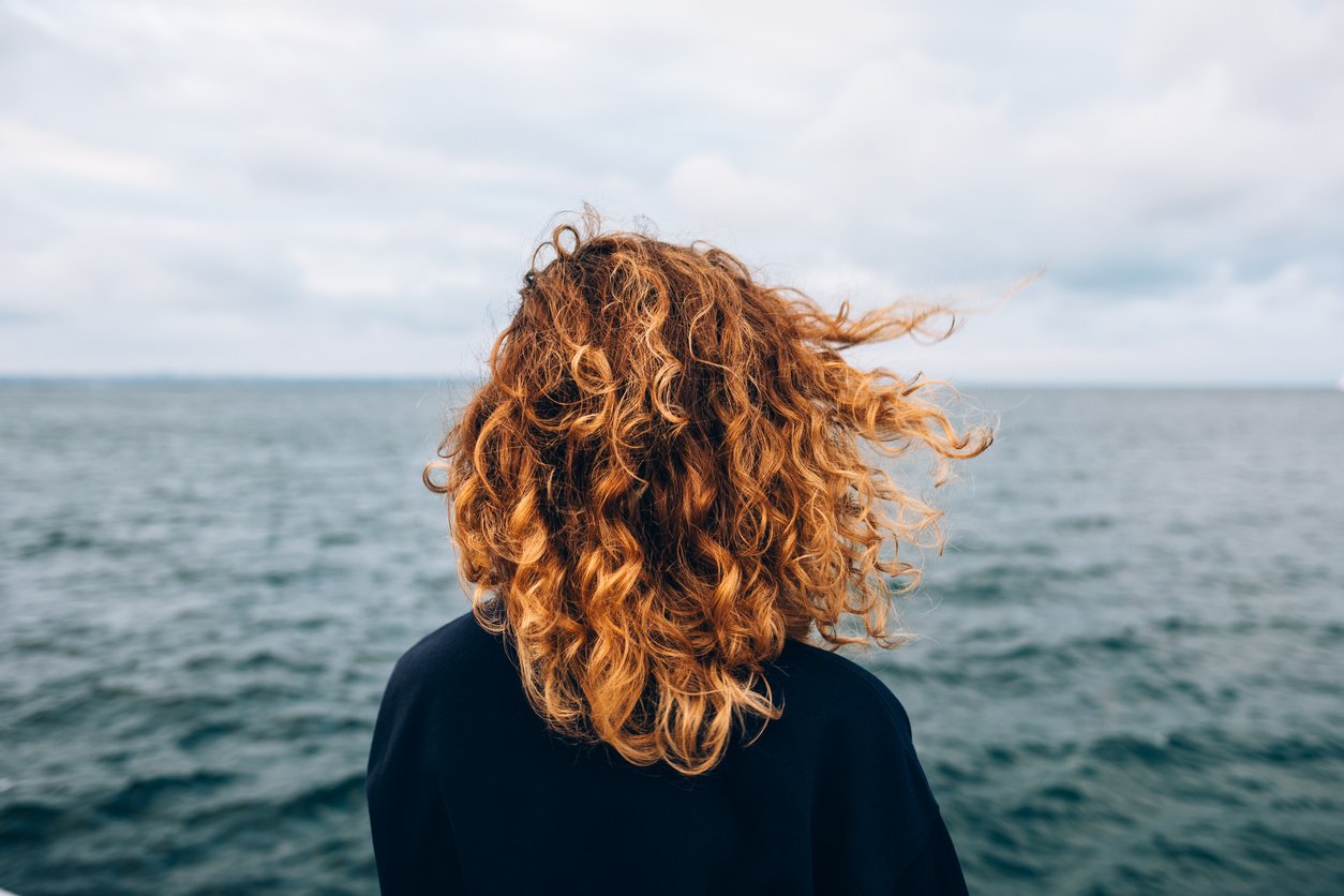 View from the back a woman with curly hair