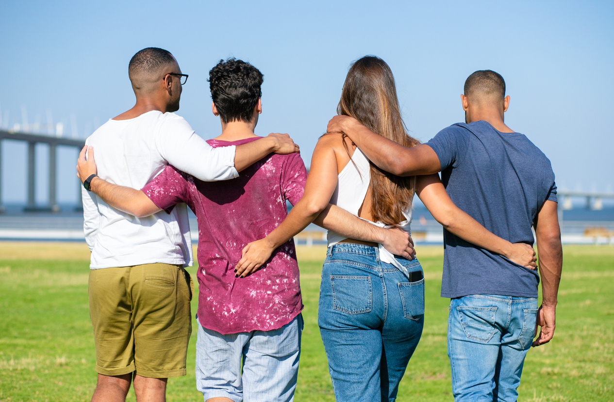 Team of friends embracing outside