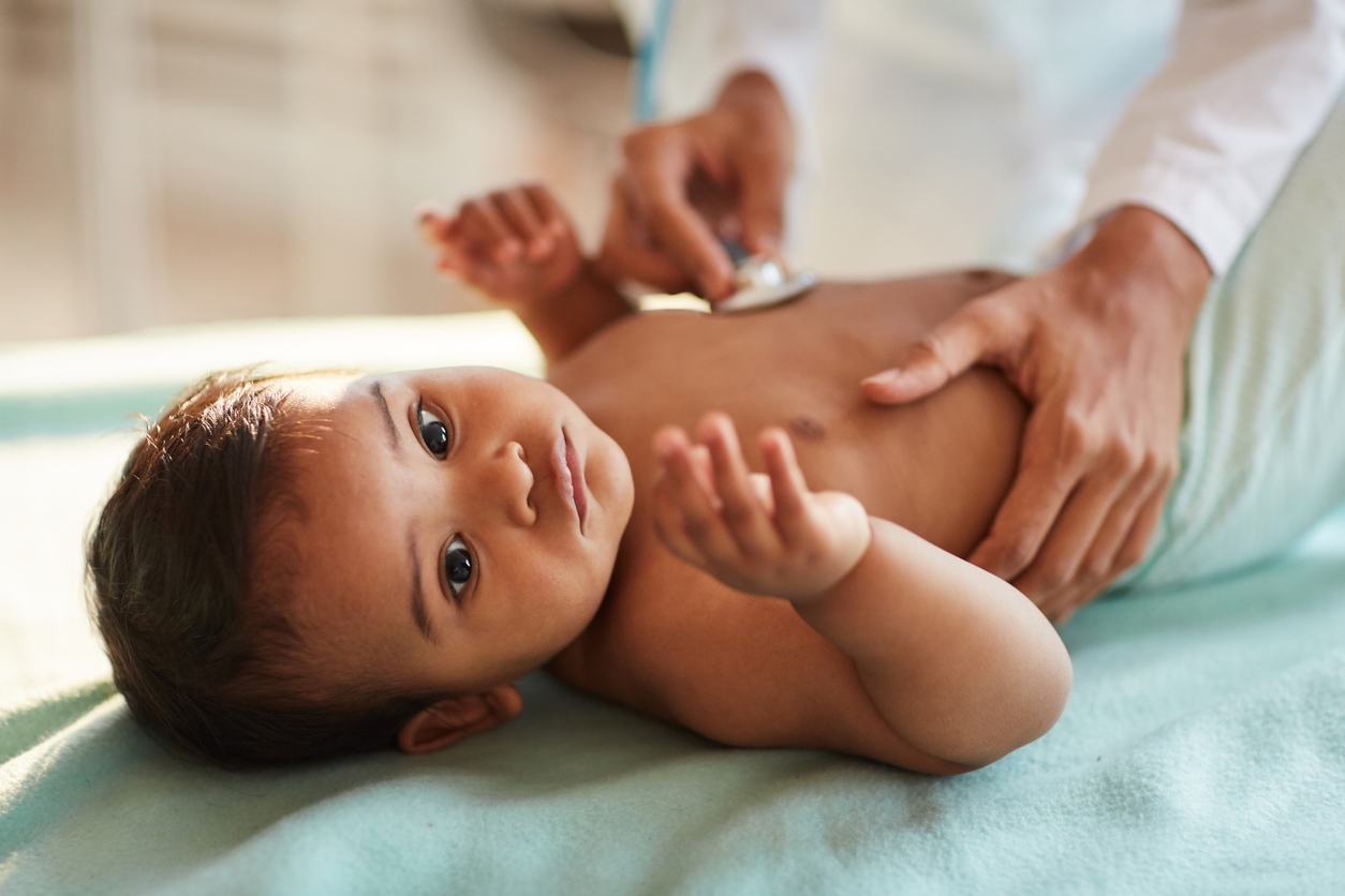 Doctor examining baby at hospital